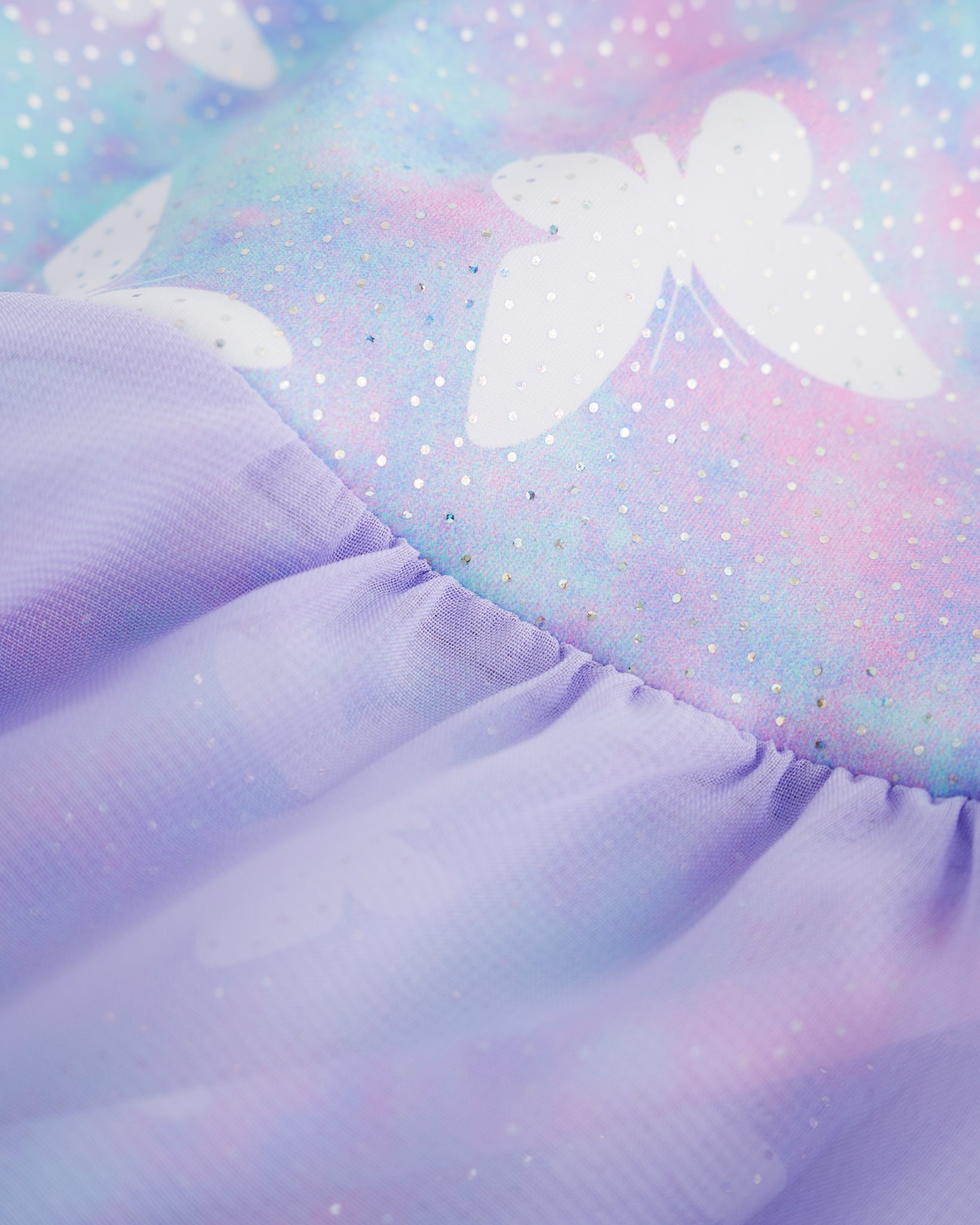 Close-up of Magic Flutter ballet dress showing the shimmering butterfly print and soft gathered lavender skirt fabric.
