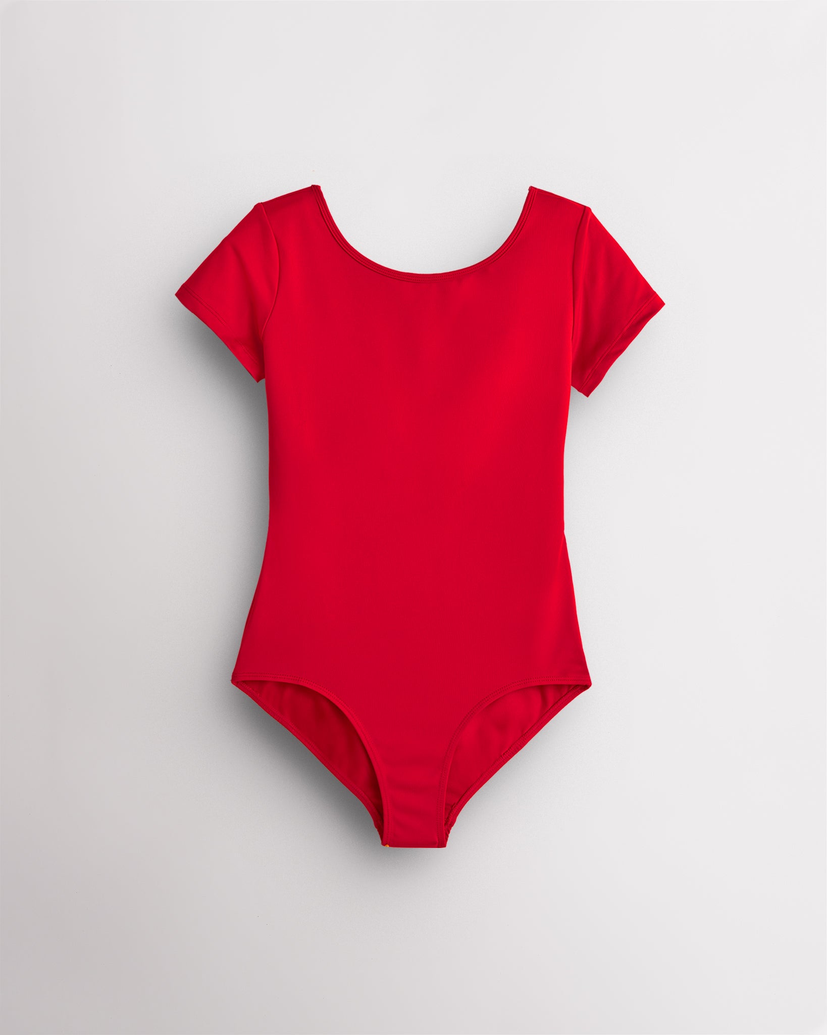 Red leotard for girls with short sleeves, scoop neckline, and smooth performance fabric for ballet and dance.