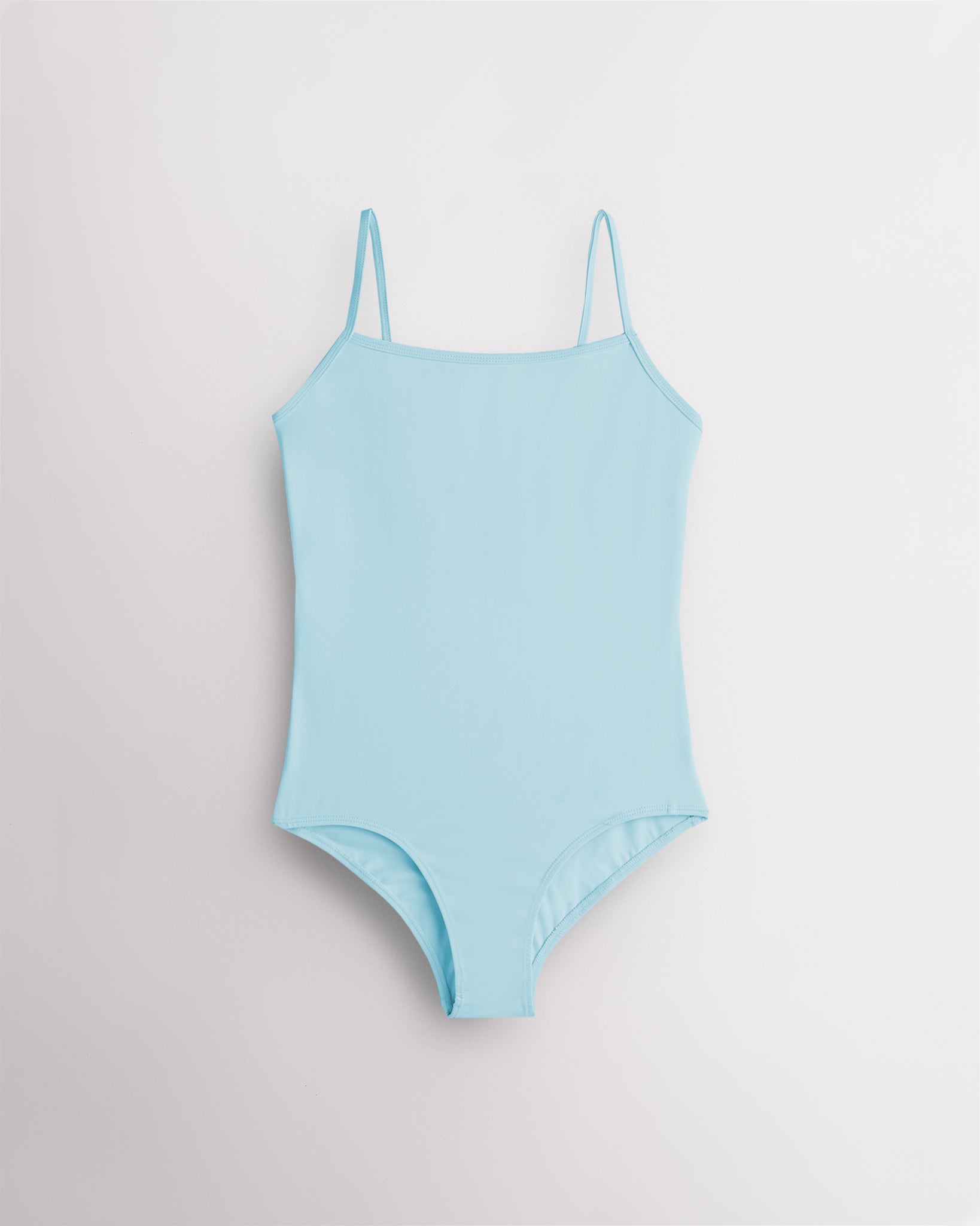 Blue girls camisole leotard with adjustable spaghetti straps, front lining, and smooth performance fabric.