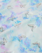 Close-up of Butterfly Mist girls unitard fabric showing butterflies, rainbows, moons, stars, and soft shimmer detail.