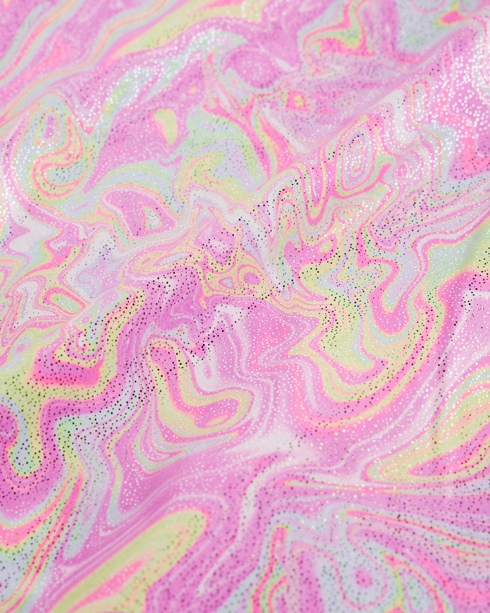 Close-up of Color Swirl girls unitard fabric showing butterflies, rainbows, moons, stars, and soft shimmer detail.