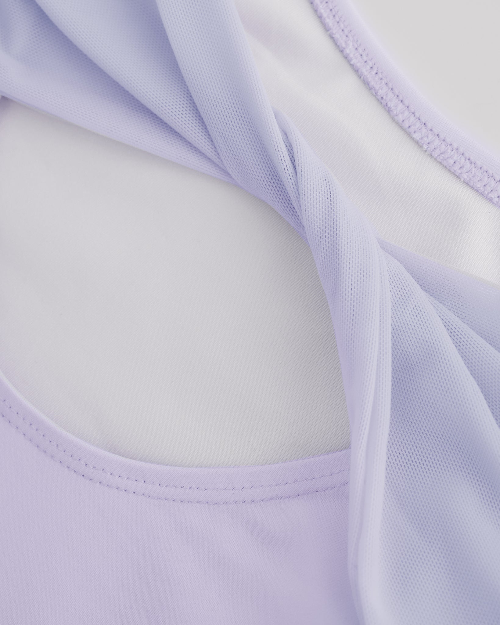 Close-up of Lavender ballet leotard showing the sheer twisted mesh back fabric and smooth performance material.
