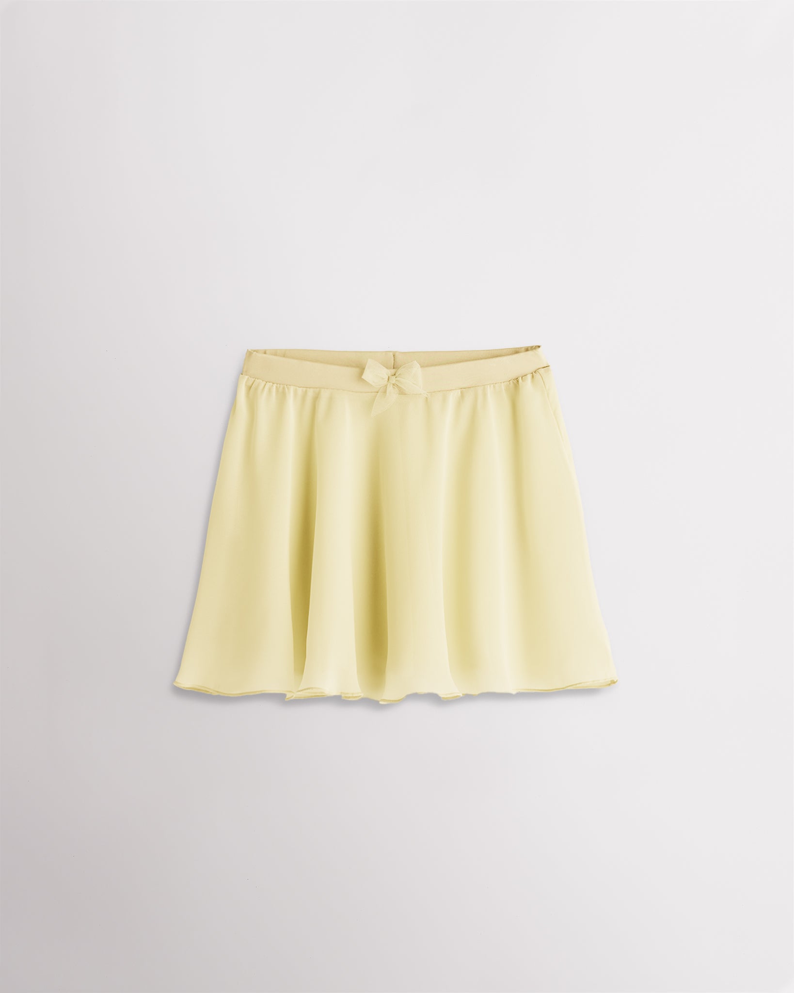 Girls lemon butter chiffon ballet dance skirt with a flowy silhouette, elastic waistband, and bow detail at the waist.