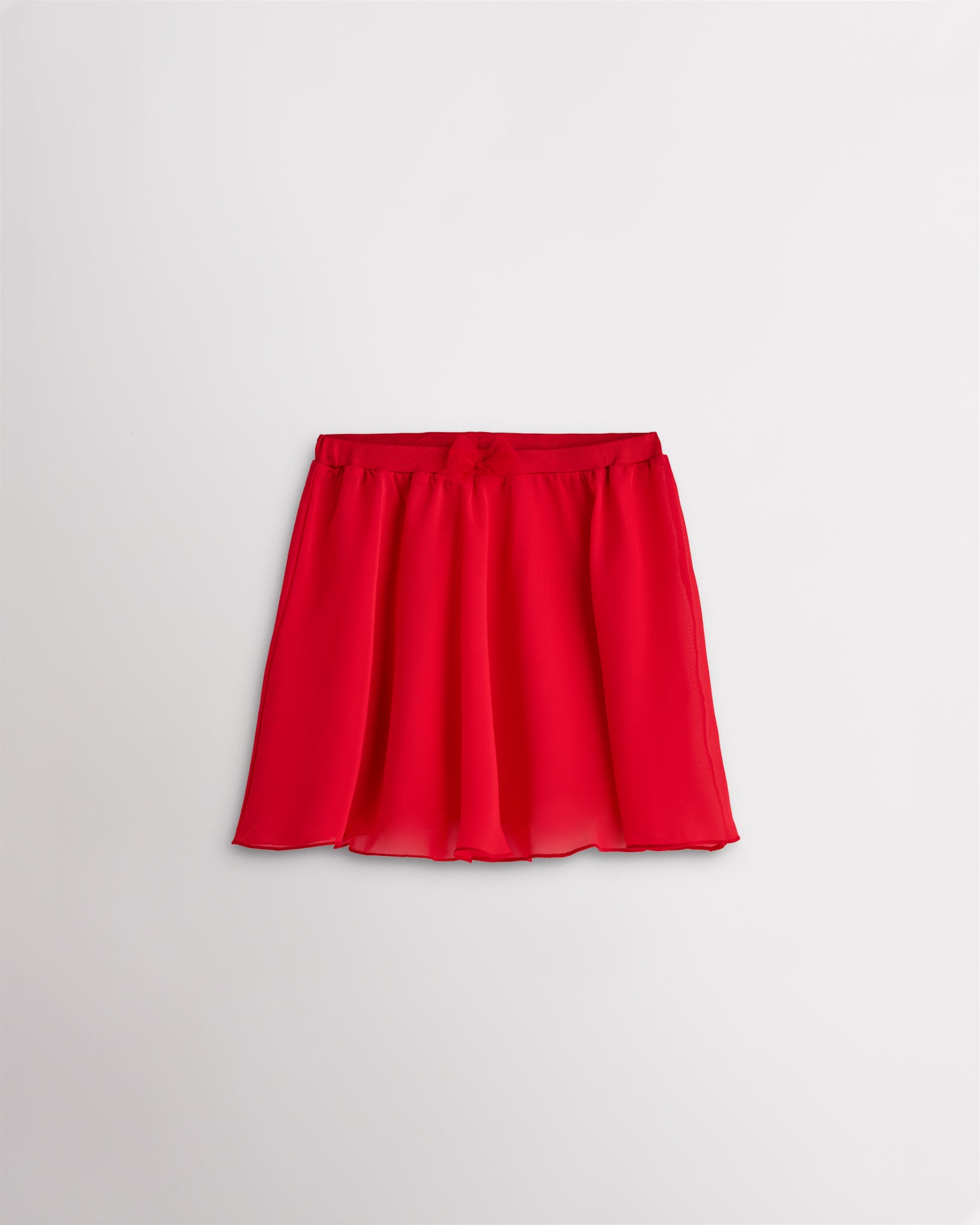 Girls red chiffon ballet dance skirt with a flowy silhouette, elastic waistband, and bow detail at the waist.
