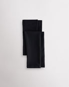 Black girls microfiber footless dance tights folded flat with elastic waistband and soft fabric for ballet and dance practice.