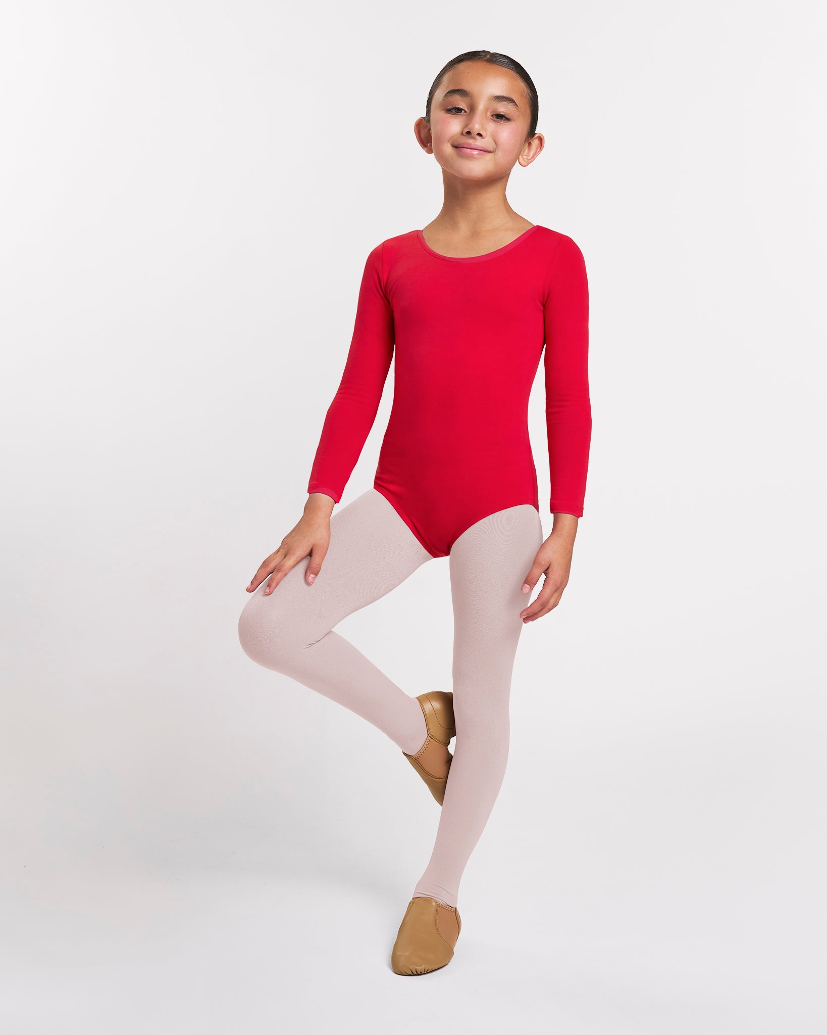Girl wearing a red long sleeve ballet leotard with ballet pink tights and tan ballet shoes in a ballet pose.