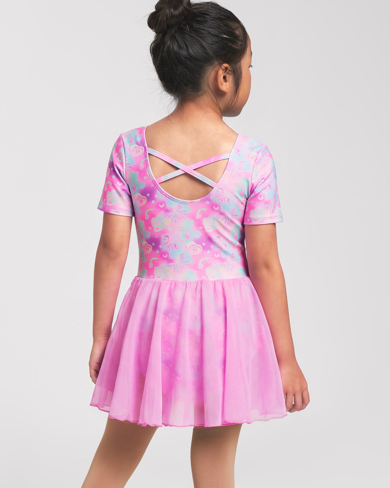 Back view of girl wearing a Bow Dreams ballet dress with crisscross back detail and attached skirt.