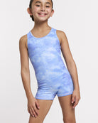 Girl wearing a Cloudburst Purple gymnastics unitard with sleeveless tank style, round neckline, fitted shorts, and allover shimmer print.
