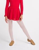 Girl wearing a red chiffon ballet skirt over white tights with tan ballet shoes.