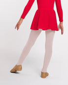 Front view of girl wearing a red pull-on chiffon skirt with white tights and tan ballet shoes.