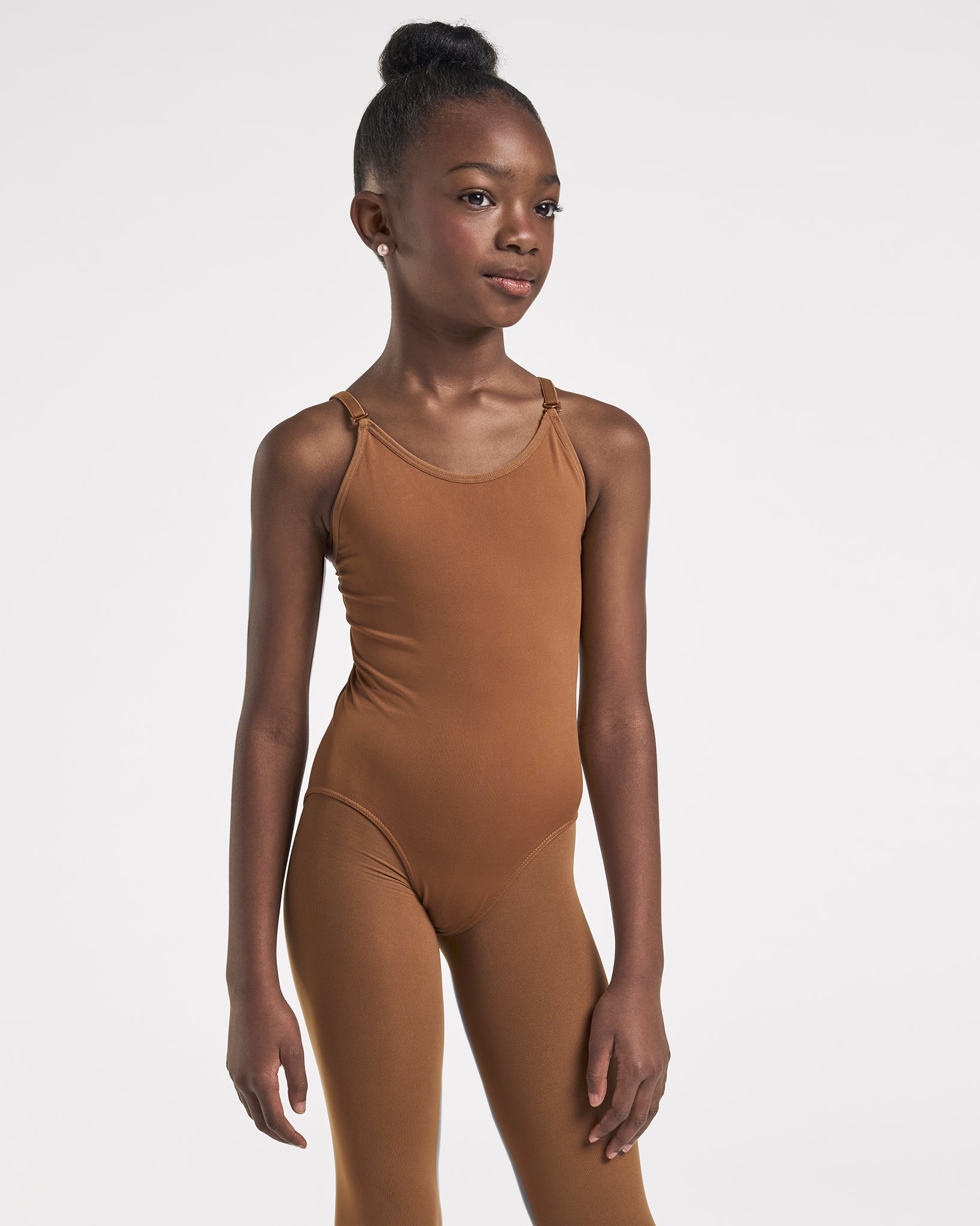 Girl wearing a Mocha camisole undergarment leotard with scoop neckline, adjustable straps, ballet leg line, and fitted silhouette for dance and performances.