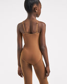 Back view of girl wearing a Mocha nude leotard with adjustable multi-way straps and a smooth fitted design for costume layering.
