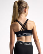 Back view of the black Stelle girls sports bra, showing the criss-cross back straps.