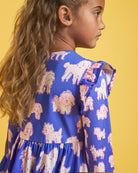 Close-up of Charlie Pals on Blue girls print dress showing ruffle shoulder detail, gathered waist, and playful in-house animal print.