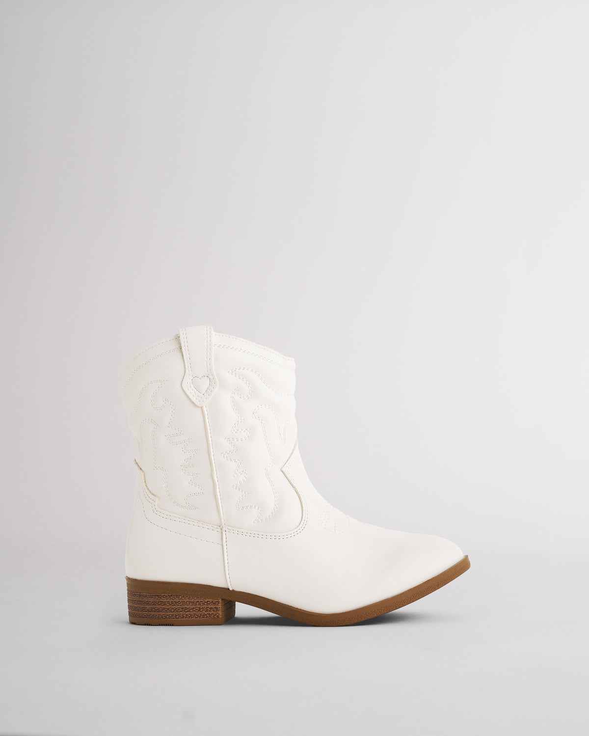 Kids white cowboy boot in a short western bootie style with tonal embroidery and a low heel, side view
