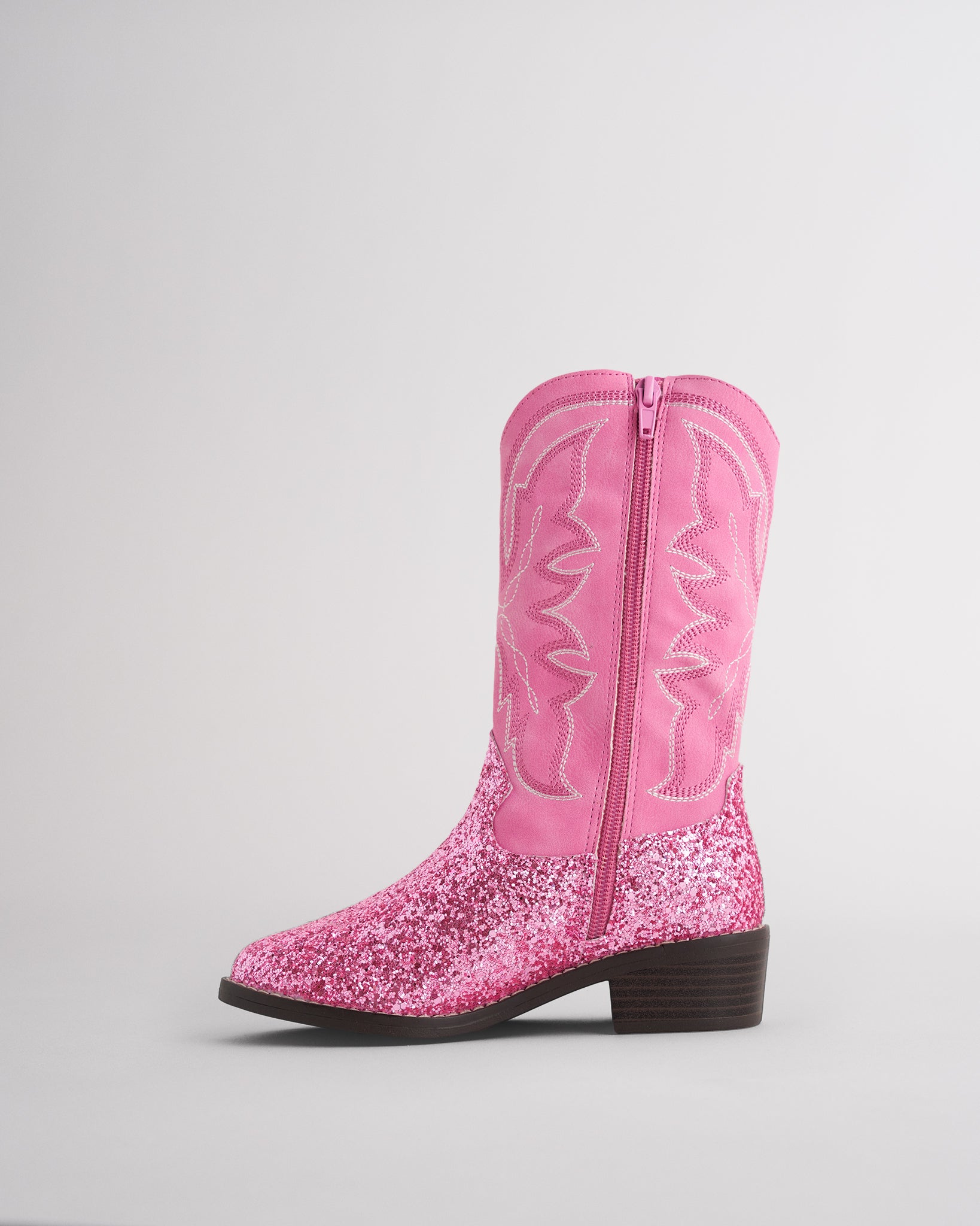 Inside view of a kids pink cowboy boot showing the side zipper for easy on and off