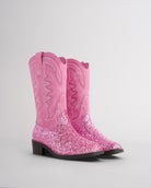 Pair of pink glitter cowgirl boots for toddlers and kids with embroidered western stitching