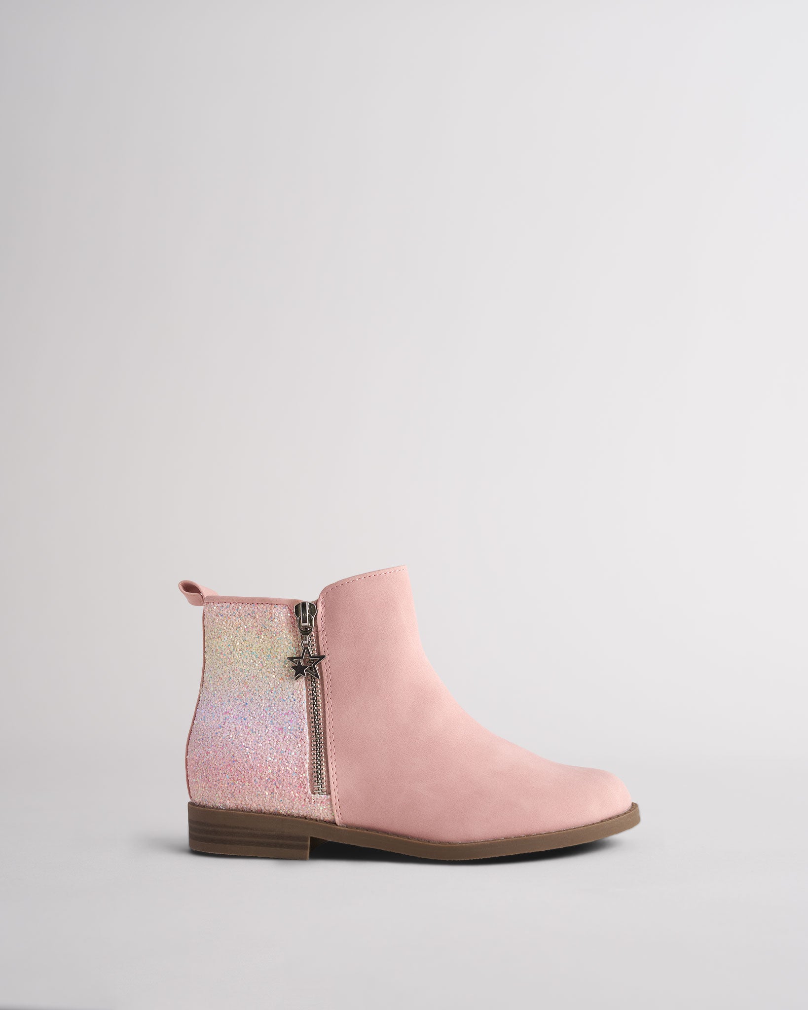 Girls pink ankle boot with ombré glitter heel panel, side zipper and silver star charm zip pull, shown from the side on a low brown heel