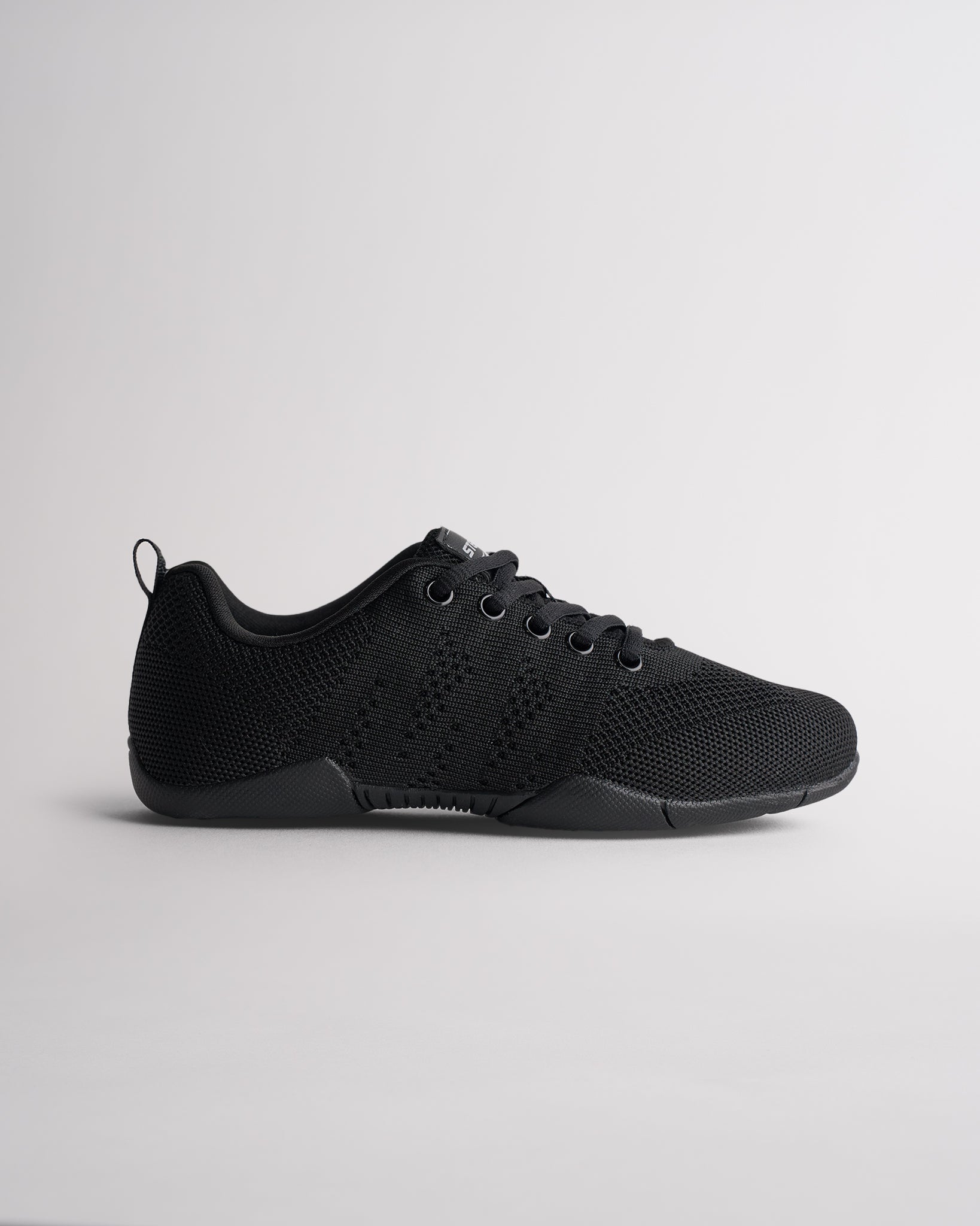 Black kids cheer shoes with knit upper and lace-up design, side profile view