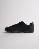 Angled view of black cheer shoes for girls showing breathable knit texture and flexible sole