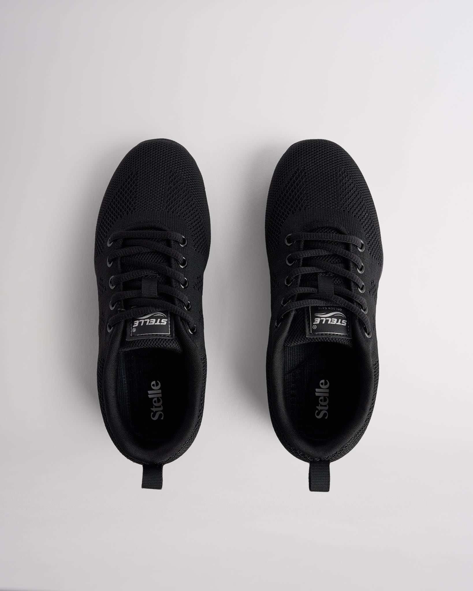 Top view of black lace-up cheer shoes with cushioned interior and Stelle logo