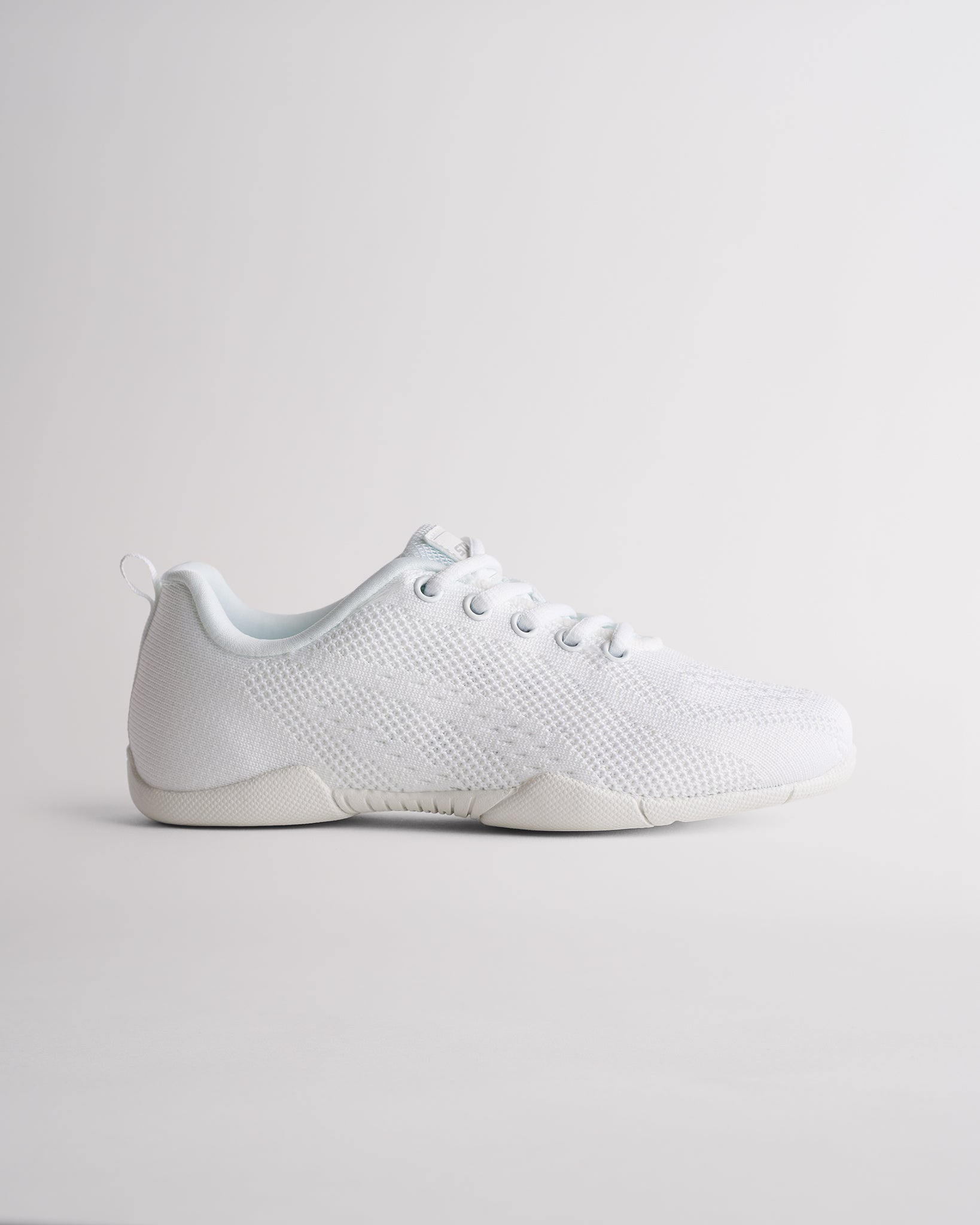 White kids cheer shoes with breathable knit upper and lace-up design, side view