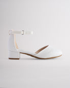 Girls’ white glitter dress shoes with a low block heel and ankle strap.