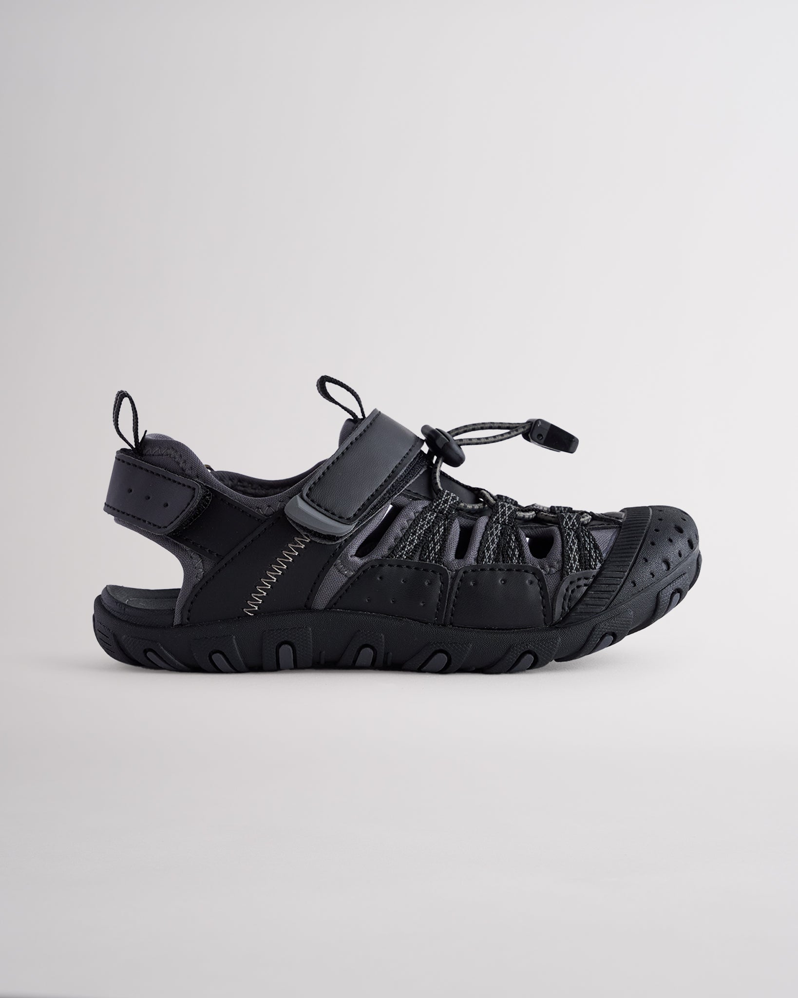 Black kids sport sandal with closed-toe protection, cord lace system, and adjustable hook-and-loop strap