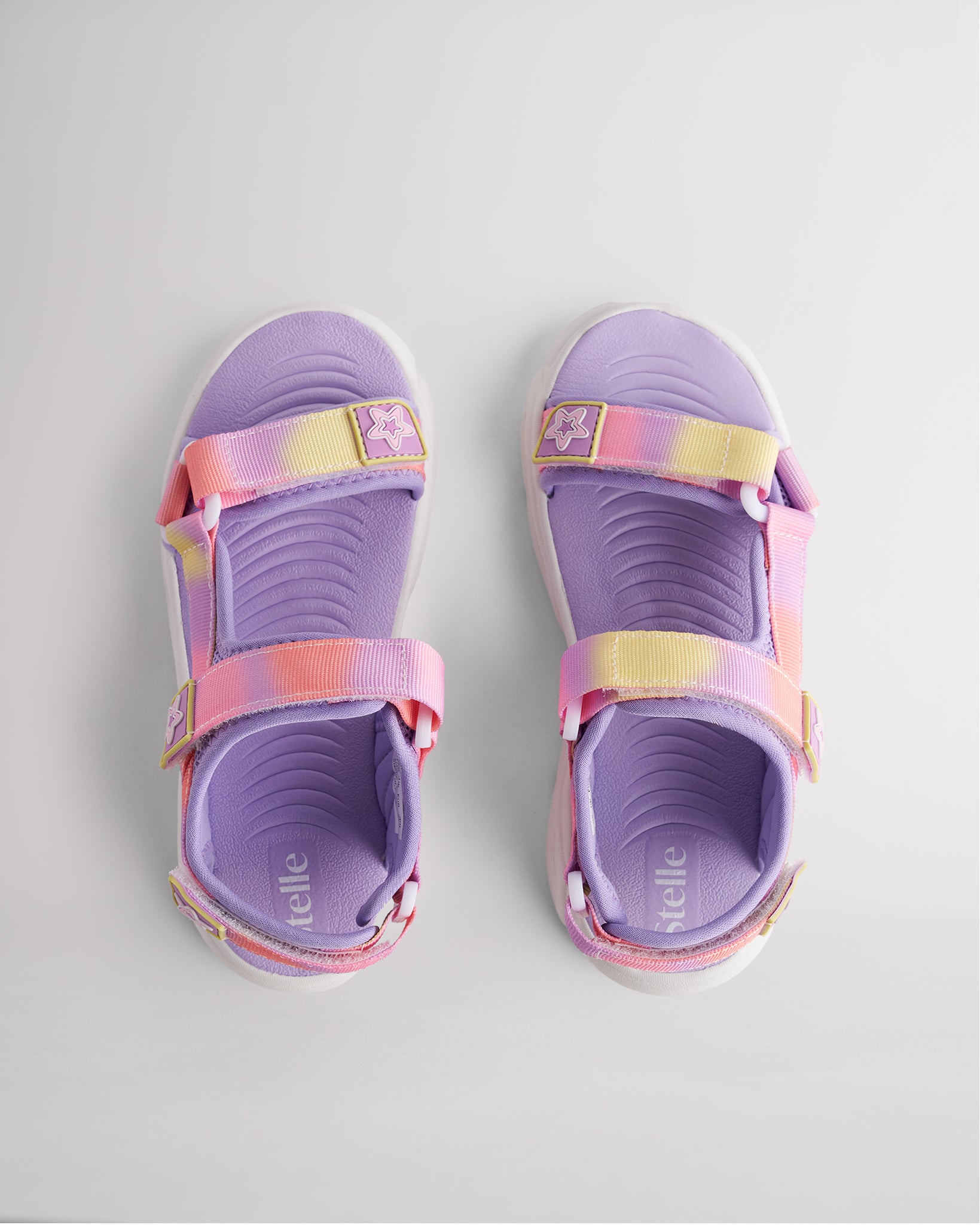Top view of sunset glow sandals for kids with three adjustable straps and textured footbed