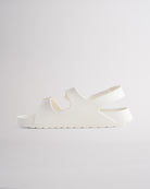 Creme sandals for kids featuring contoured footbed, flexible design, and secure back strap
