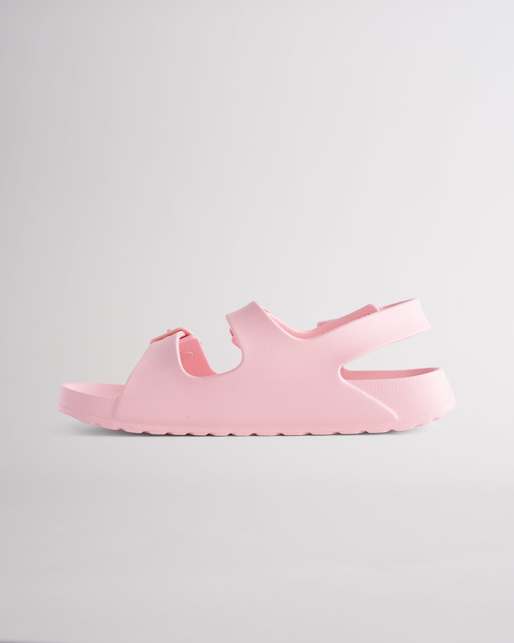 Pink sandals for kids featuring contoured footbed, flexible design, and secure back strap