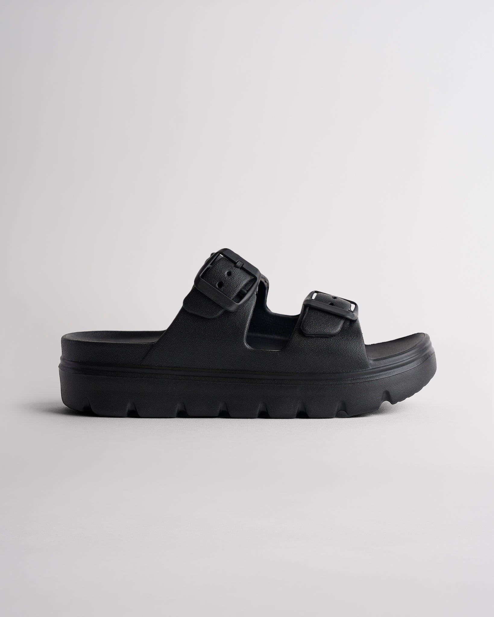 Black Stelle Kids StelleCloud Buckled Slide with adjustable buckle straps, contoured footbed, and supportive casual design.