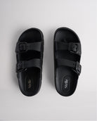 Top view of black Stelle Kids StelleCloud Buckled Slide with two buckle straps, contoured footbed, and Stelle logo detail.