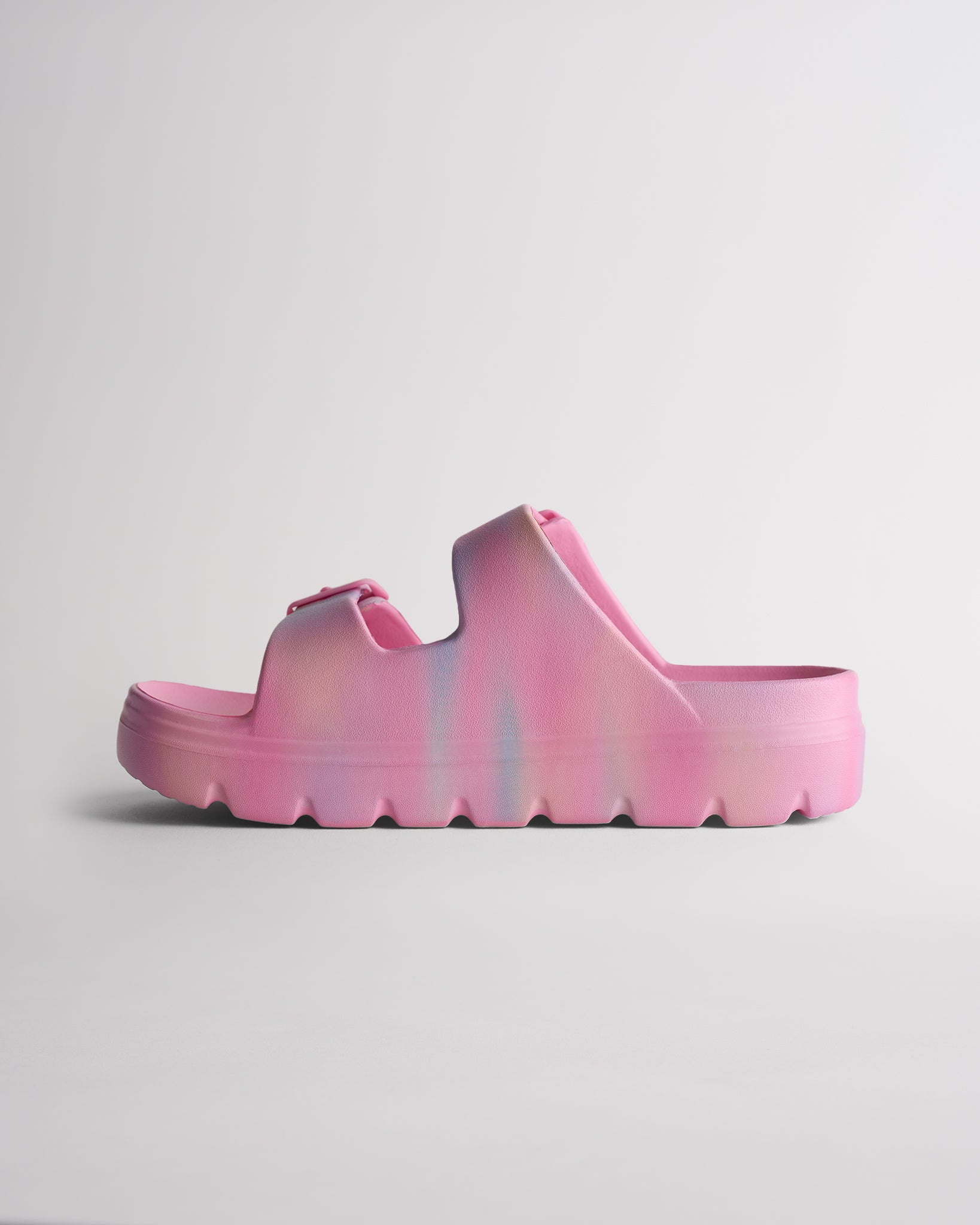 Side view of Cotton Candy Ombre Stelle Kids StelleCloud Buckled Slide showing the easy slide-on design, raised sole, and adjustable straps.