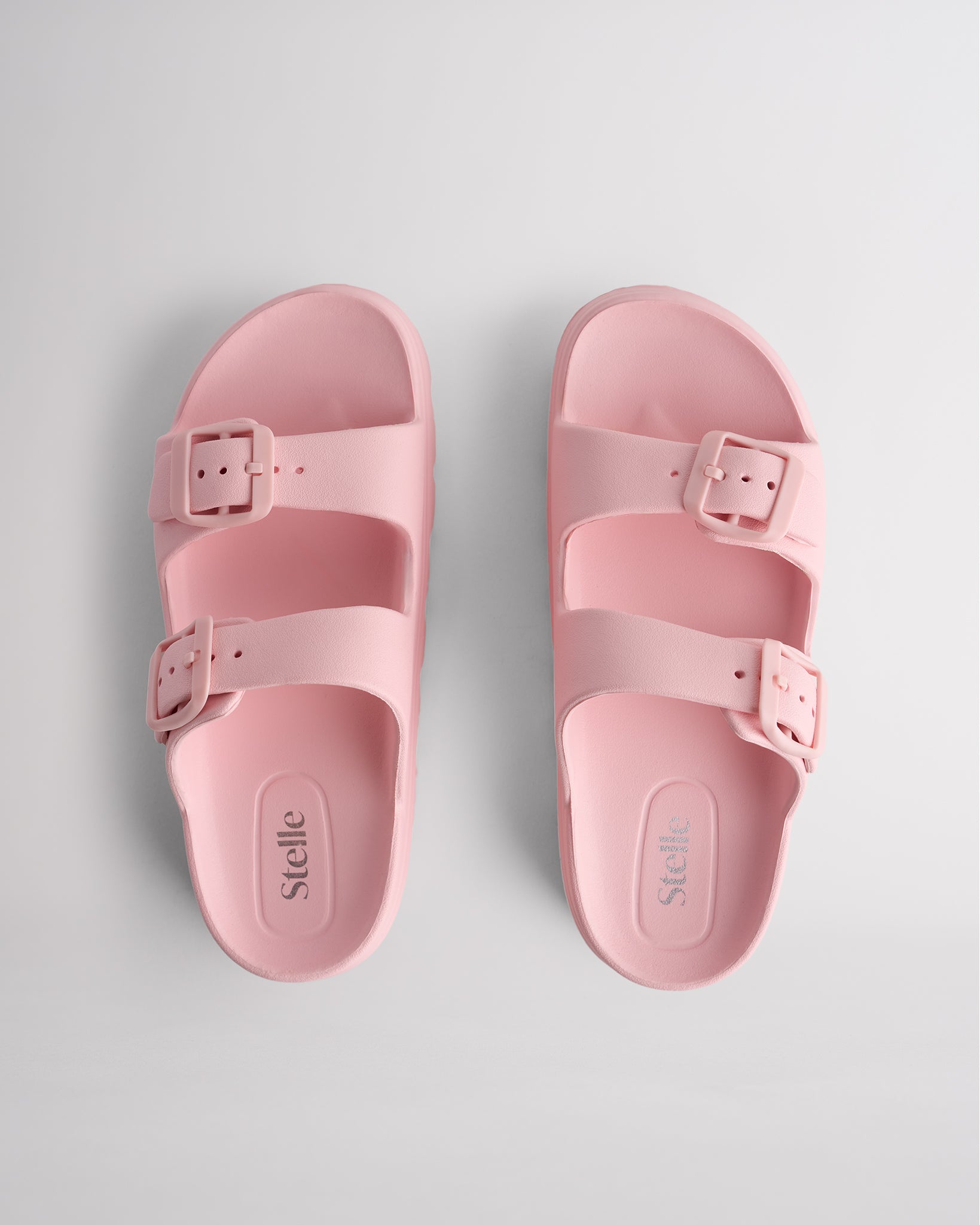 Top view of pink Stelle Kids StelleCloud Buckled Slide with two buckle straps, contoured footbed, and Stelle logo detail.