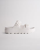 White Stelle Kids StelleCloud Buckled Slide with adjustable buckle straps, contoured footbed, and supportive casual design.