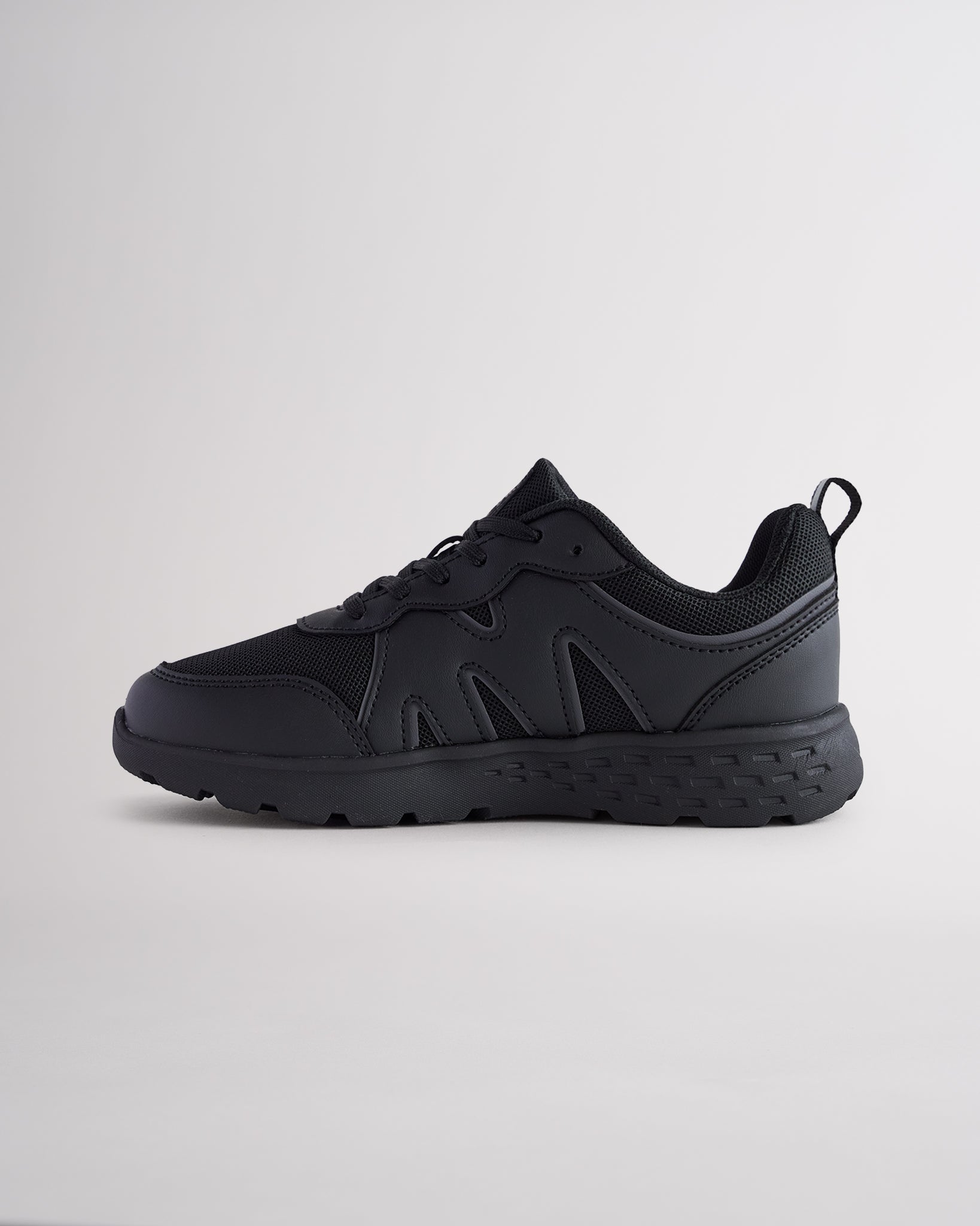 Ninja Black lightweight kids’ sneakers with breathable mesh uppers, a cushioned insole, and a durable outsole.