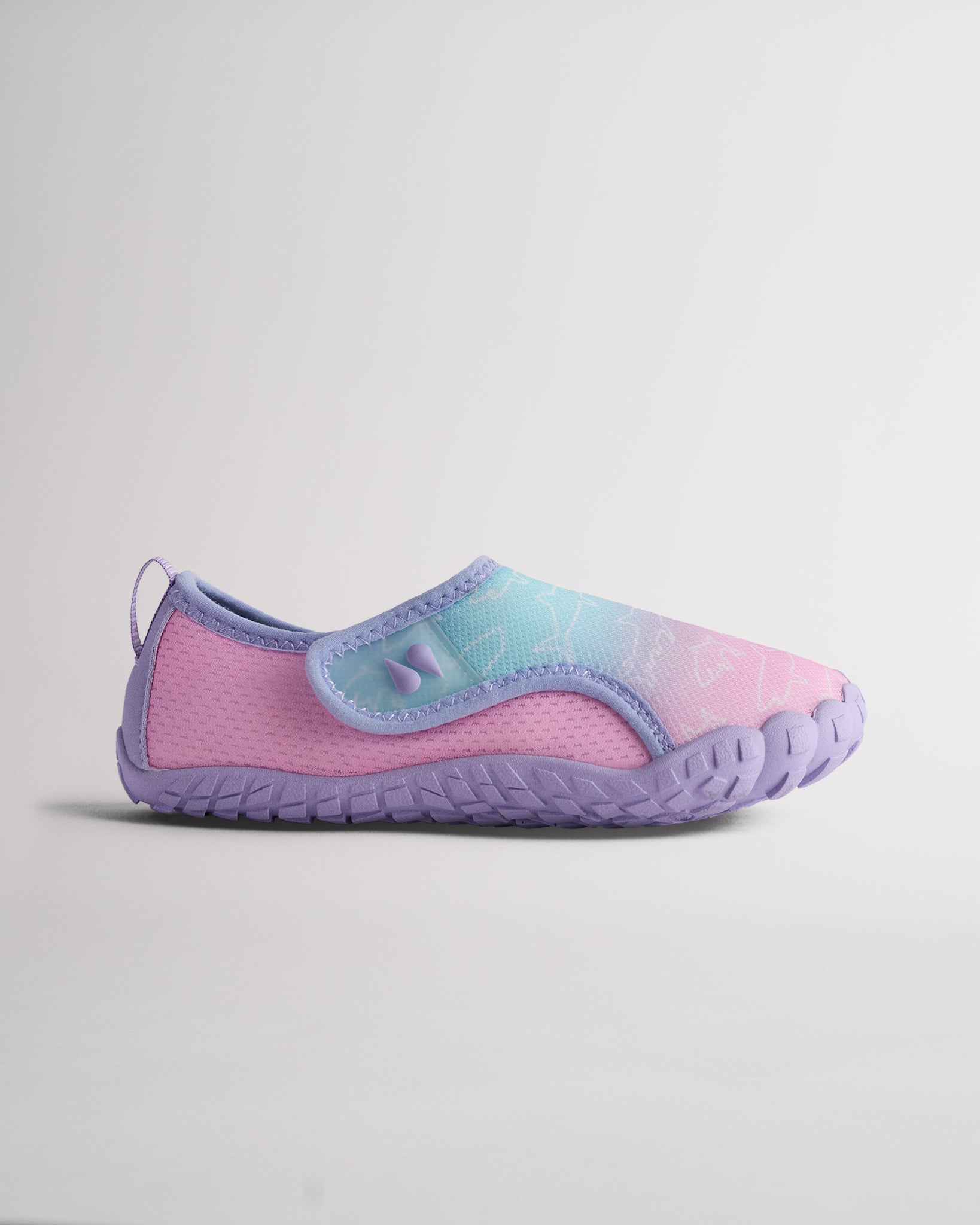 Side view of Kids StelleMesh slip-on water shoe with pastel mermaid ombre upper, wide velcro closure, and purple traction outsole.