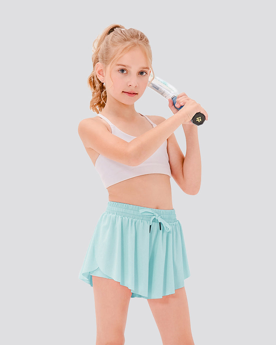 Girl holding a tennis racket, wearing light blue butterfly shorts