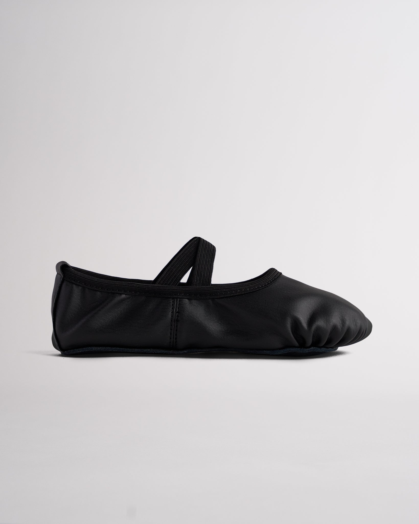 Black kids Rosie vegan leather ballet shoe with elastic strap, lightweight PU leather upper, and flexible full sole design.