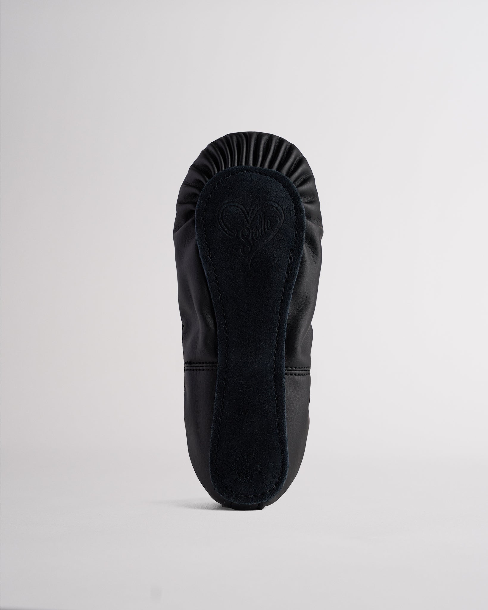 Sole view of black kids vegan leather ballet shoe showing full sole construction and durable outsole for dance practice.
