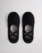 Pair of black kids stretch canvas ballet shoes with cross elastic straps, breathable canvas uppers, and split sole design.