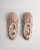 Kids glitter ballet shoes in gold glitter with crisscross elastic straps, top view