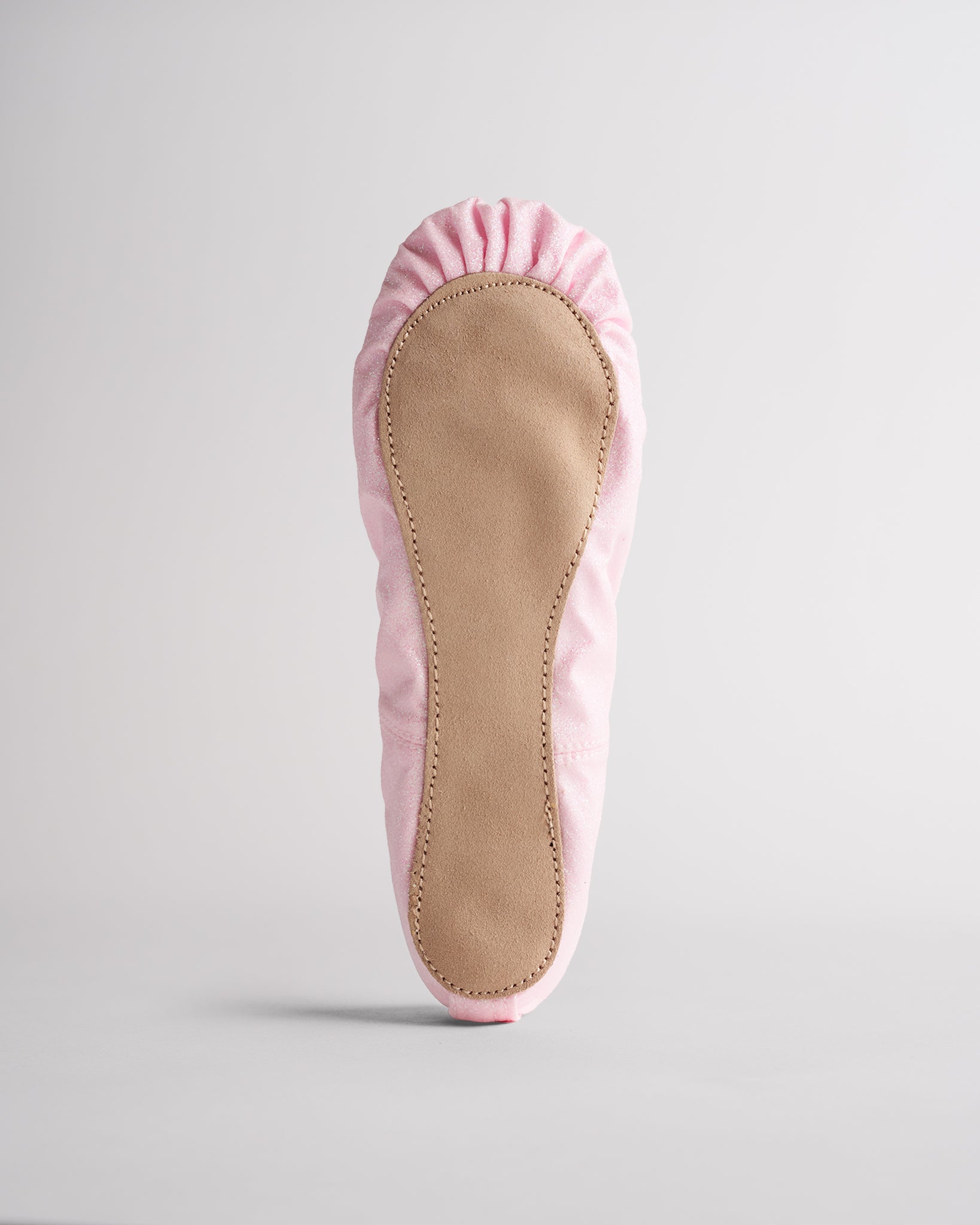 Kids pink glitter ballet shoes with suede sole, bottom view