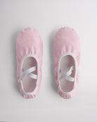 Kids glitter ballet shoes in pink glitter with crisscross elastic straps, top view
