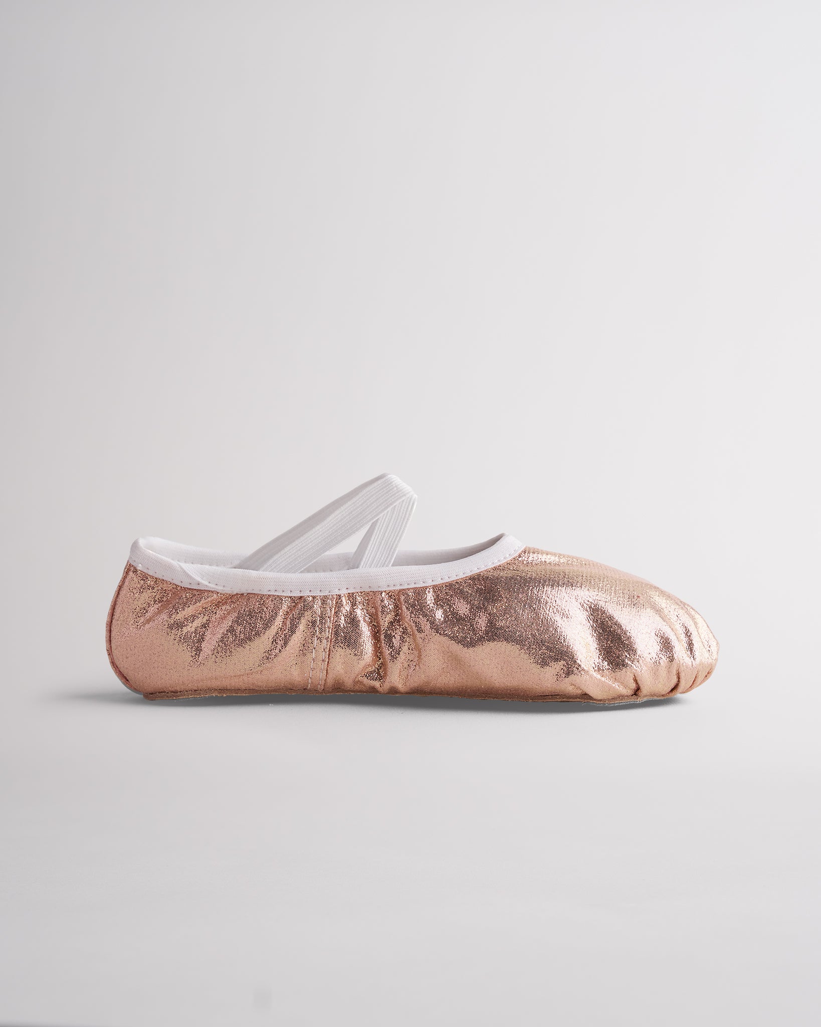 Metallic gold ballet shoes with elastic cross straps and flexible sole for dance class