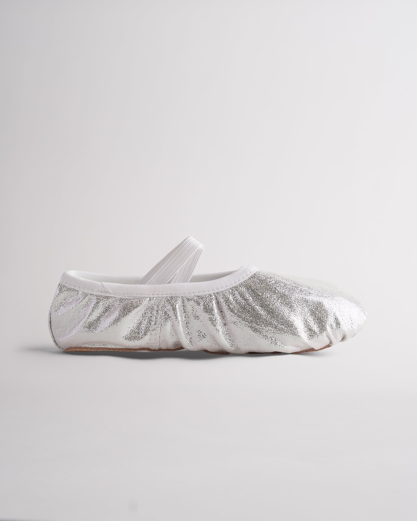 Metallic silver ballet shoes with elastic cross straps and flexible sole for dance class