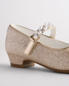 Close-up of girls mary jane shoes featuring anti-slip sole and low heel for stability