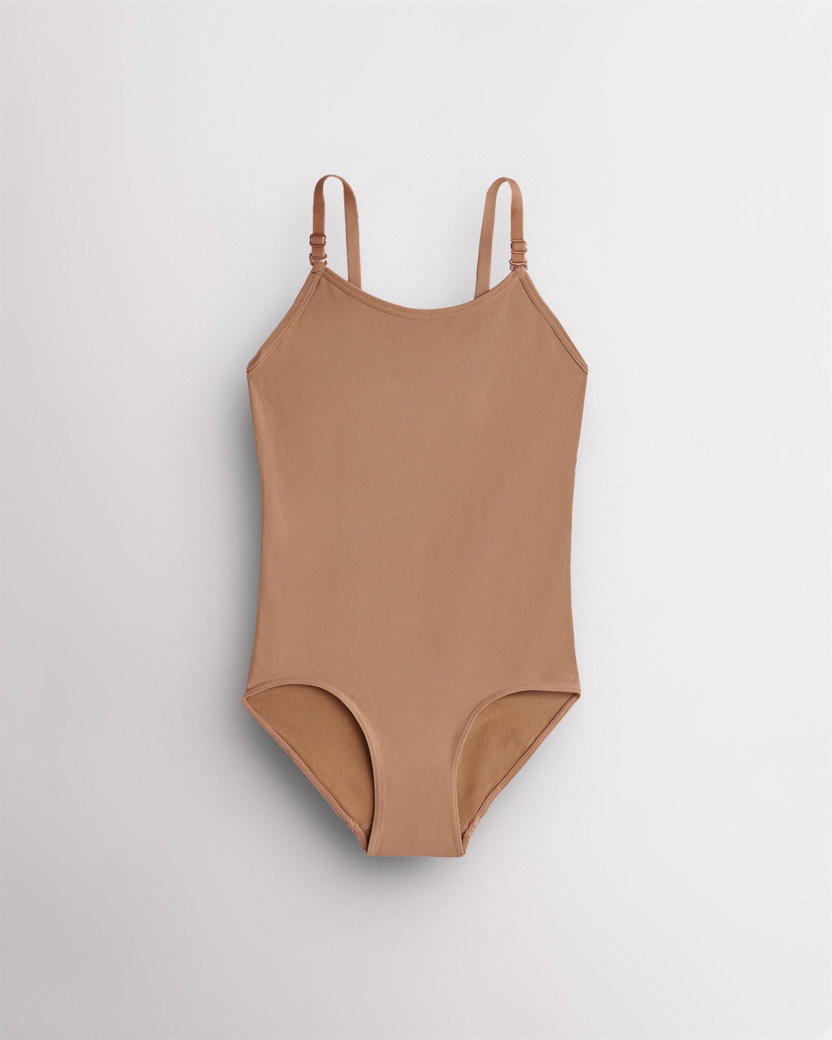 Warm Tan nude leotard for girls with camisole straps, scoop neckline, ballet leg line, and fitted silhouette for dance and performances.