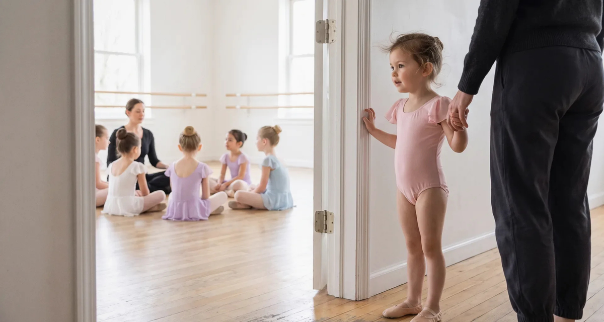 Young child arriving at her first ballet class for kids with a parent